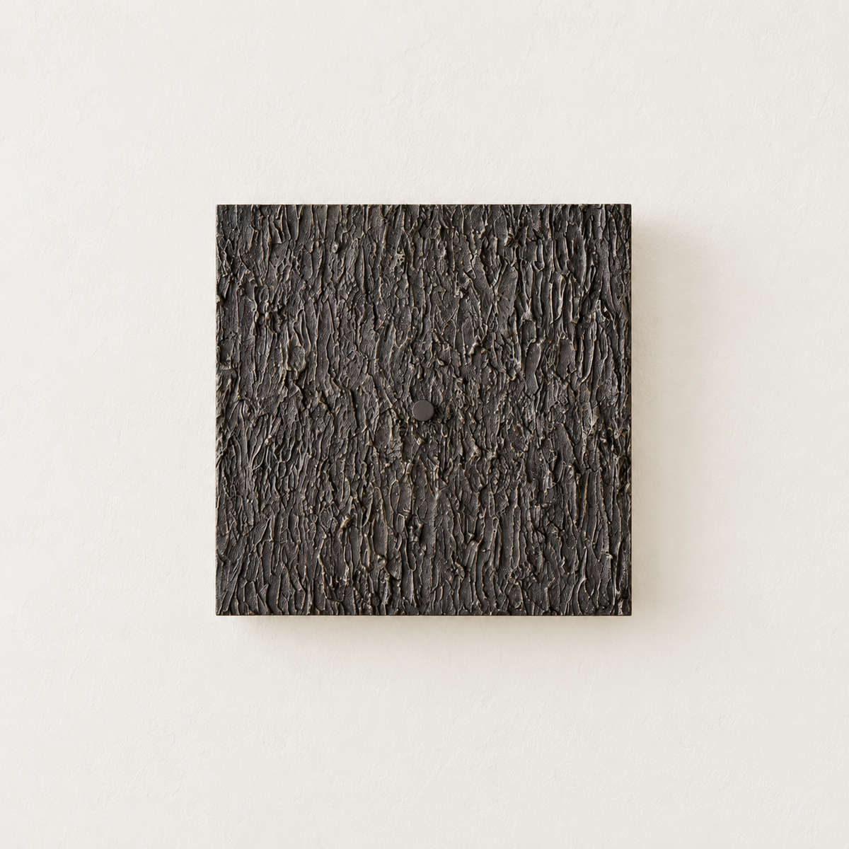 Unlit Ratera square wall sconce with dark textured metal relief and a round central cap.