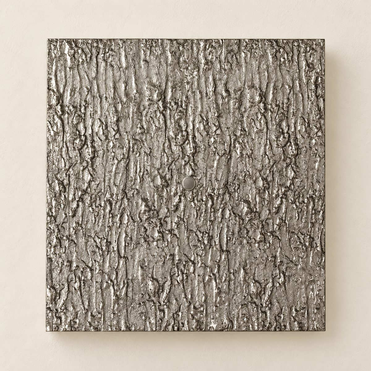 Front view of the silver-toned Ratera relief wall sconce and its round central cap.
