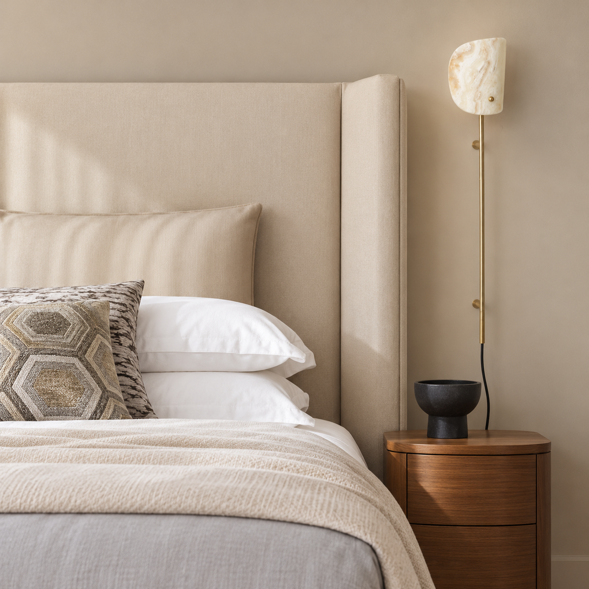 Valen onyx and brass wall rail lamp, mounted beside a bed