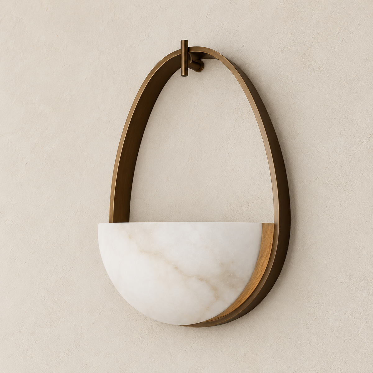 Alabaster half-bowl wall sconce in an oval bronze frame, switched off.