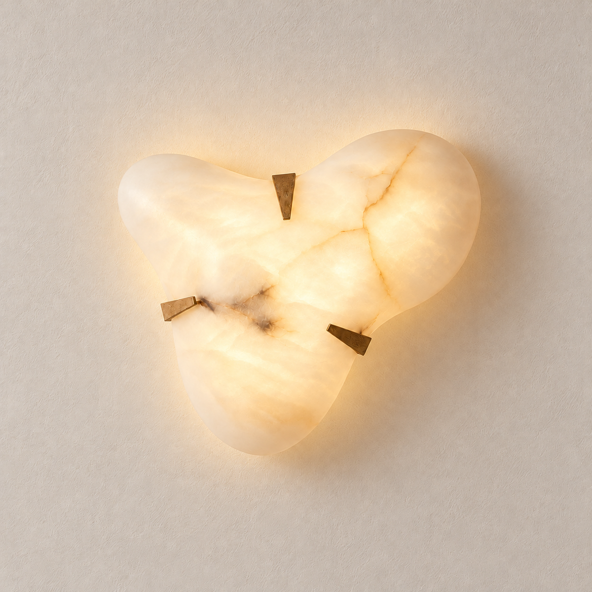 Alabaster cloud sconce glowing softly with its natural stone veining visible.