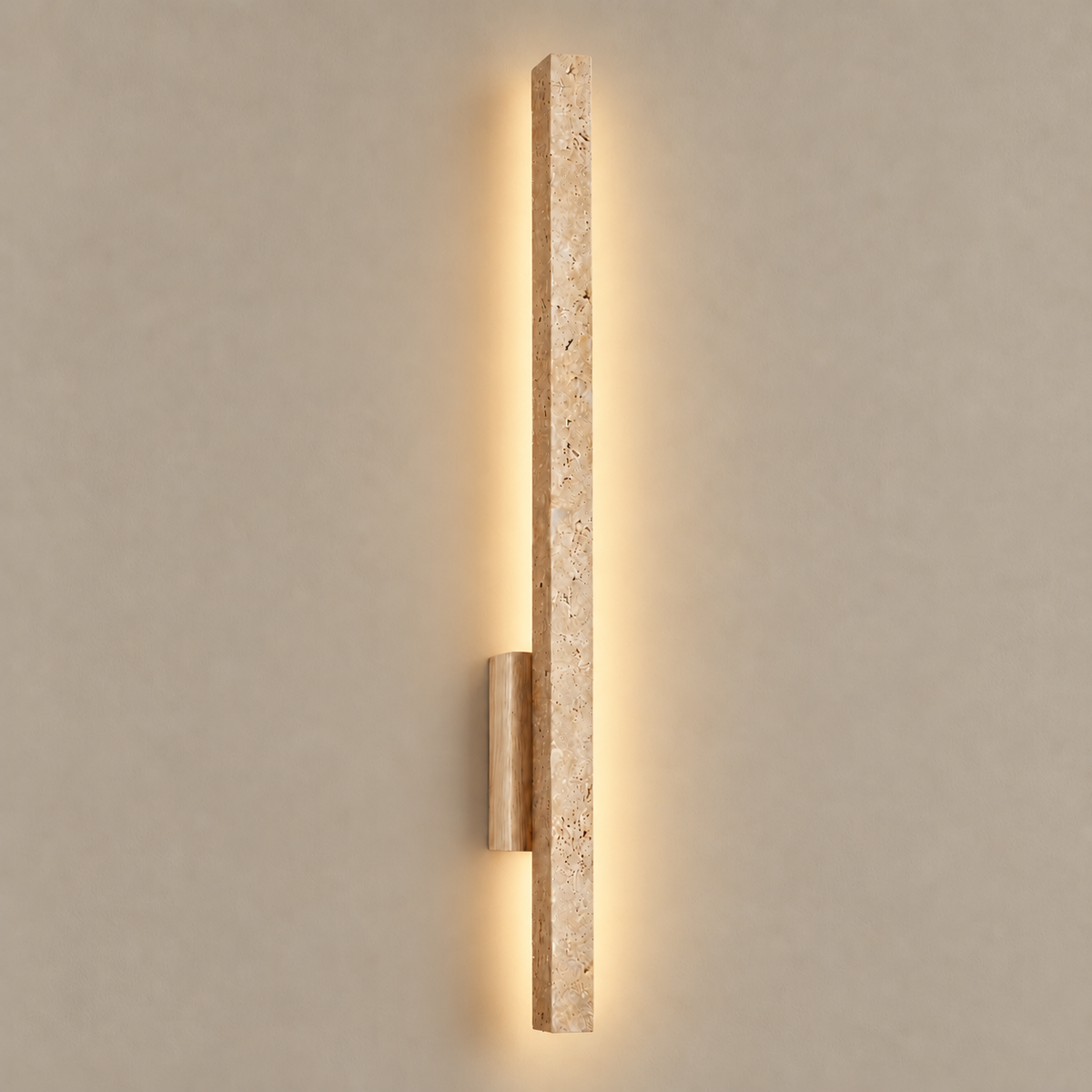 Travertine and wood wall sconce, illuminated on a stone-beige wall