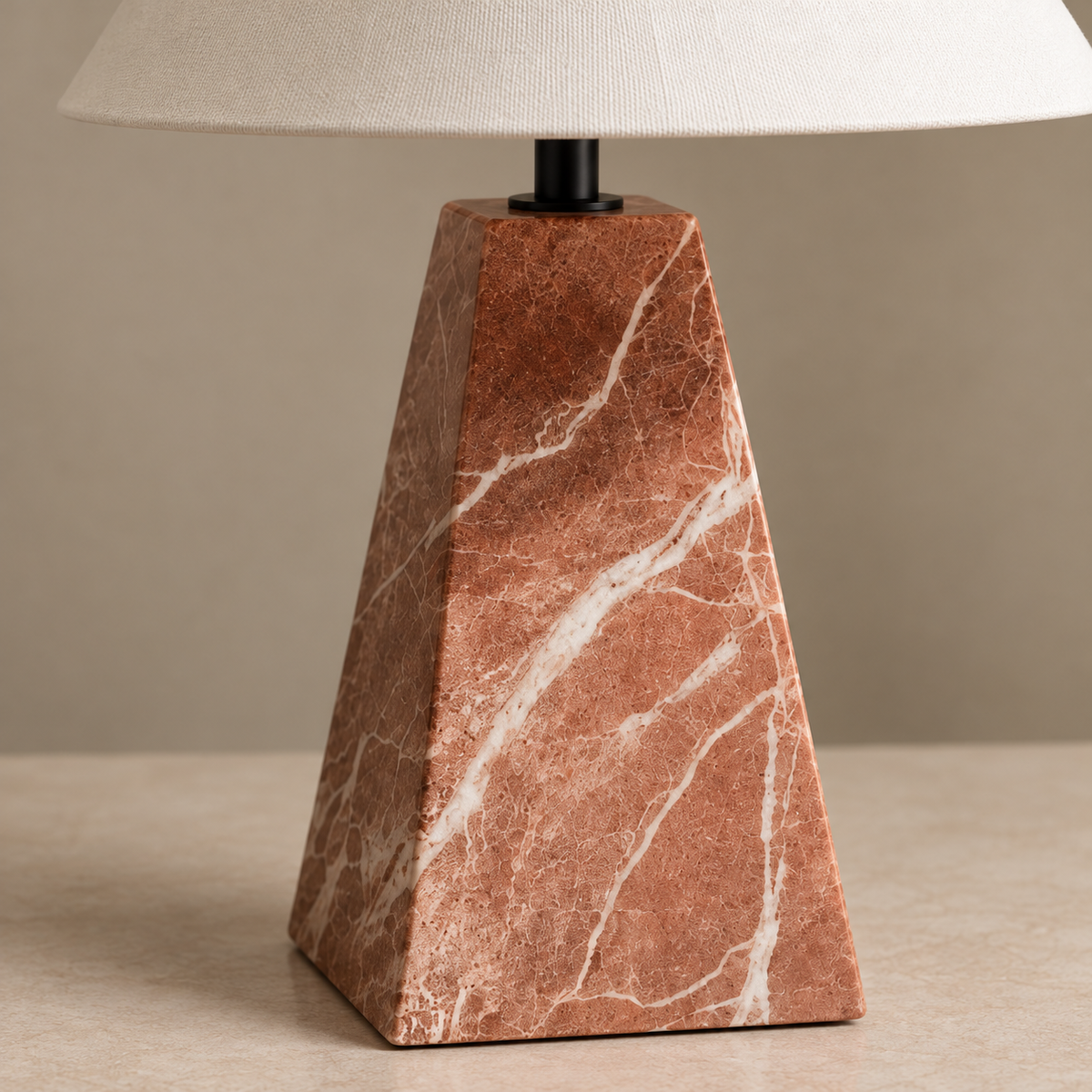 White veins across the faceted red marble base