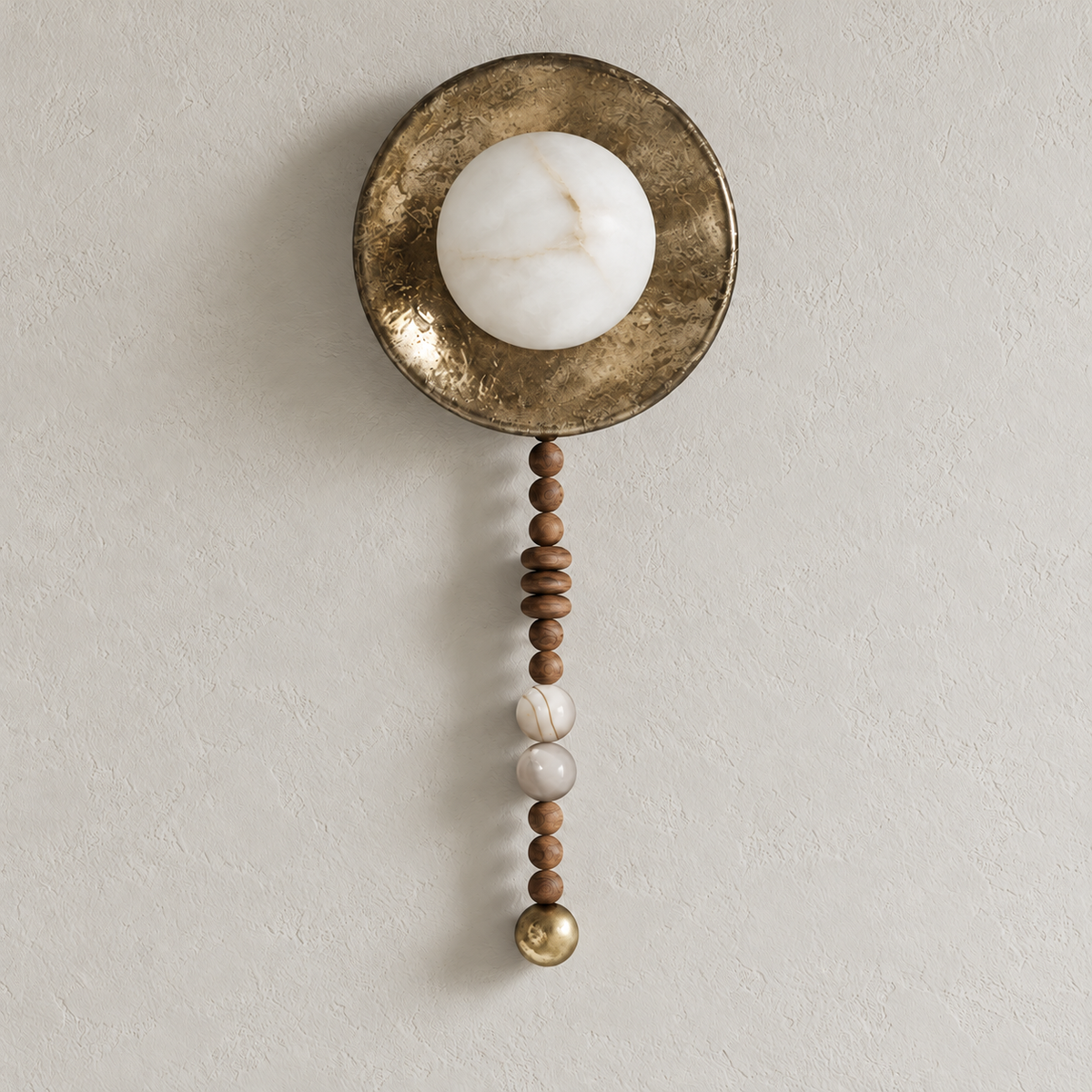 Angled view of the alabaster and wood bead wall sconce, showing its shallow round backplate and hanging bead strand.