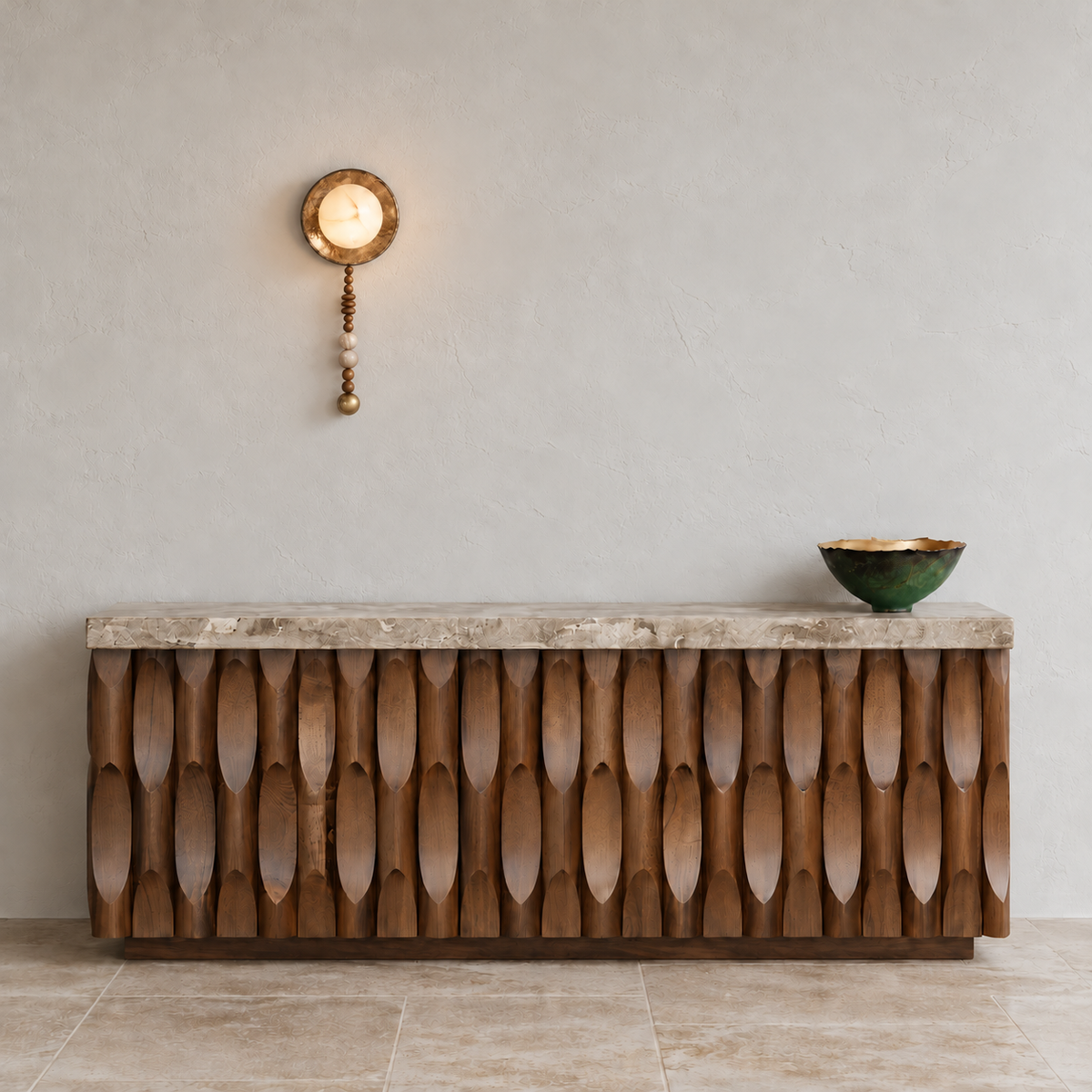 Alabaster and wood bead wall sconce mounted above a sculpted wood console in a naturally lit entryway.