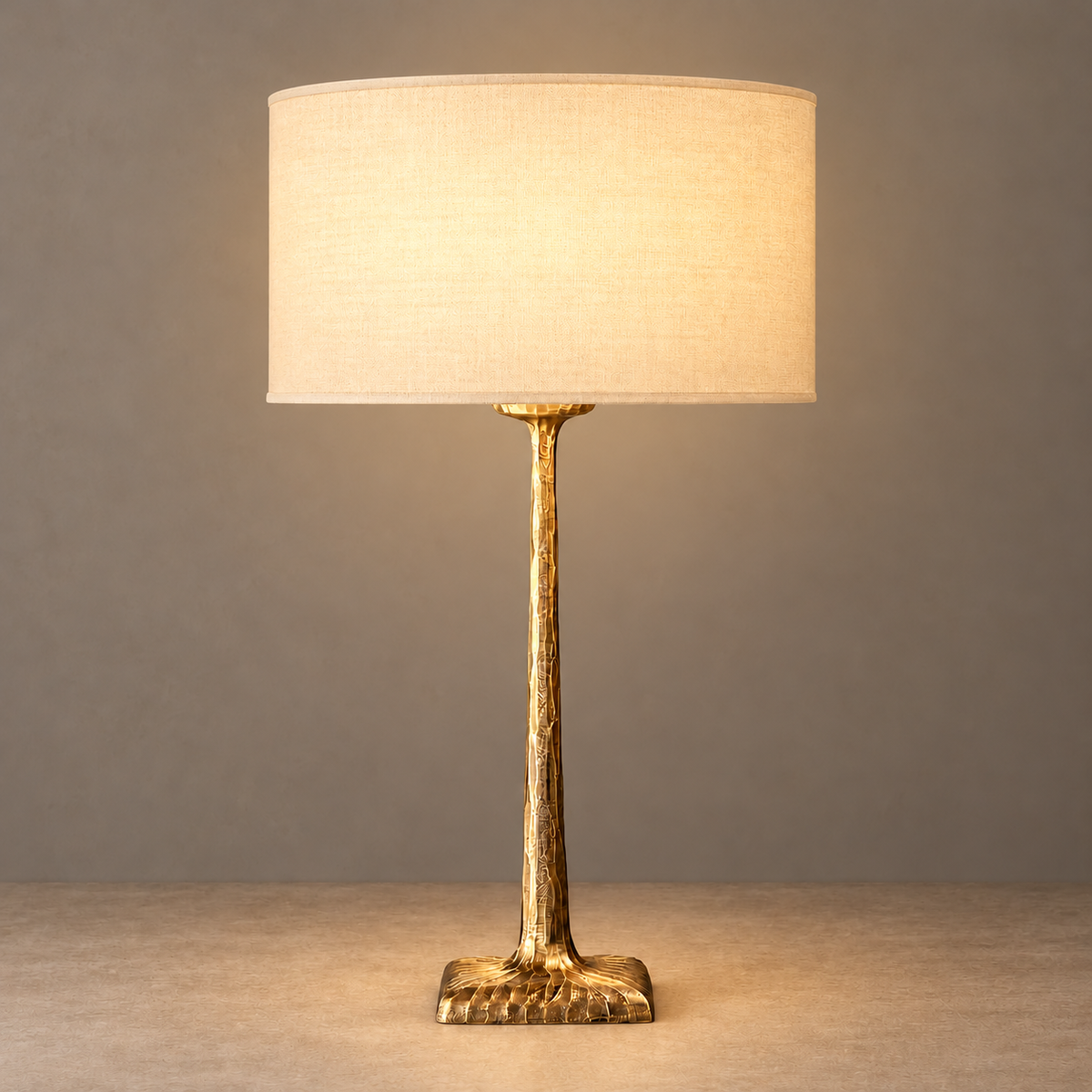 Hammered copper table lamp with its fabric shade illuminated.