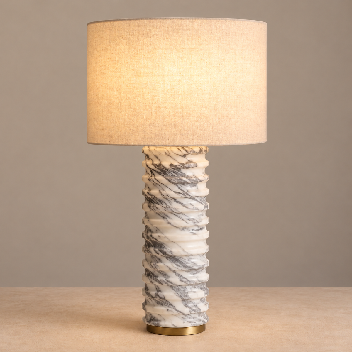 Marble table lamp with its ivory linen shade illuminated