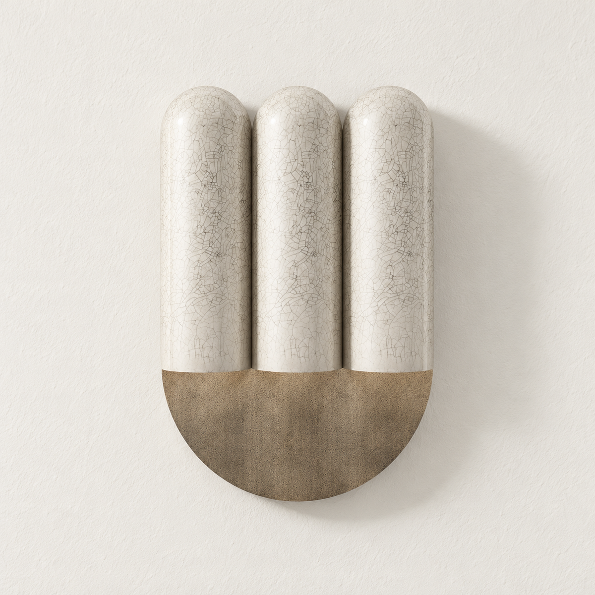 Triple crackle ceramic wall sconce mounted on ivory plaster, switched off.