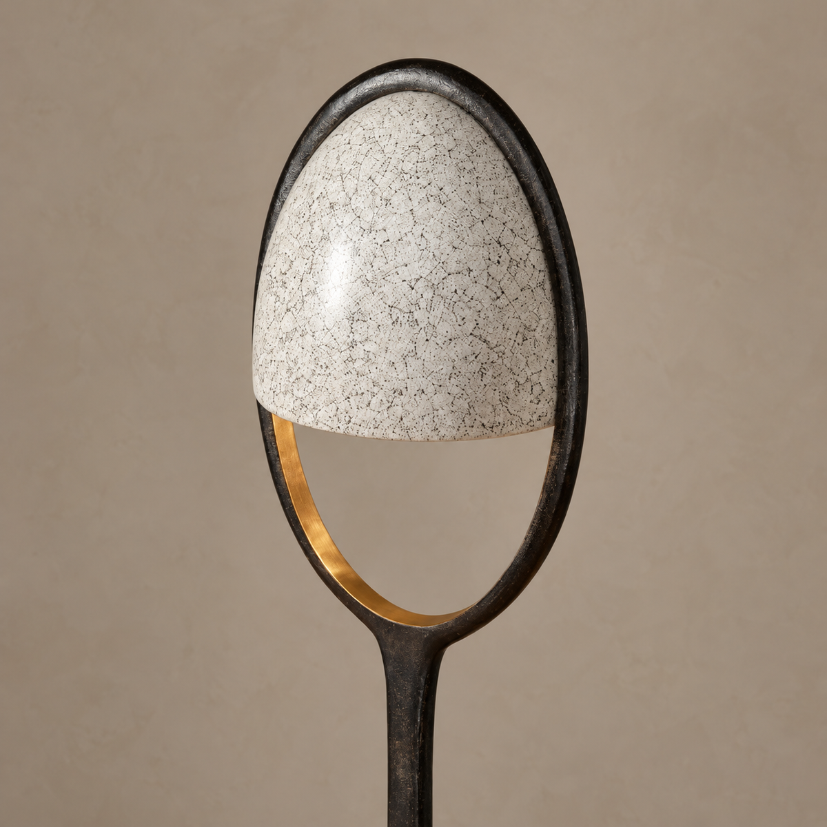 Close view of Cup’s eggshell-textured shade, brass inner rim and open lower oval.