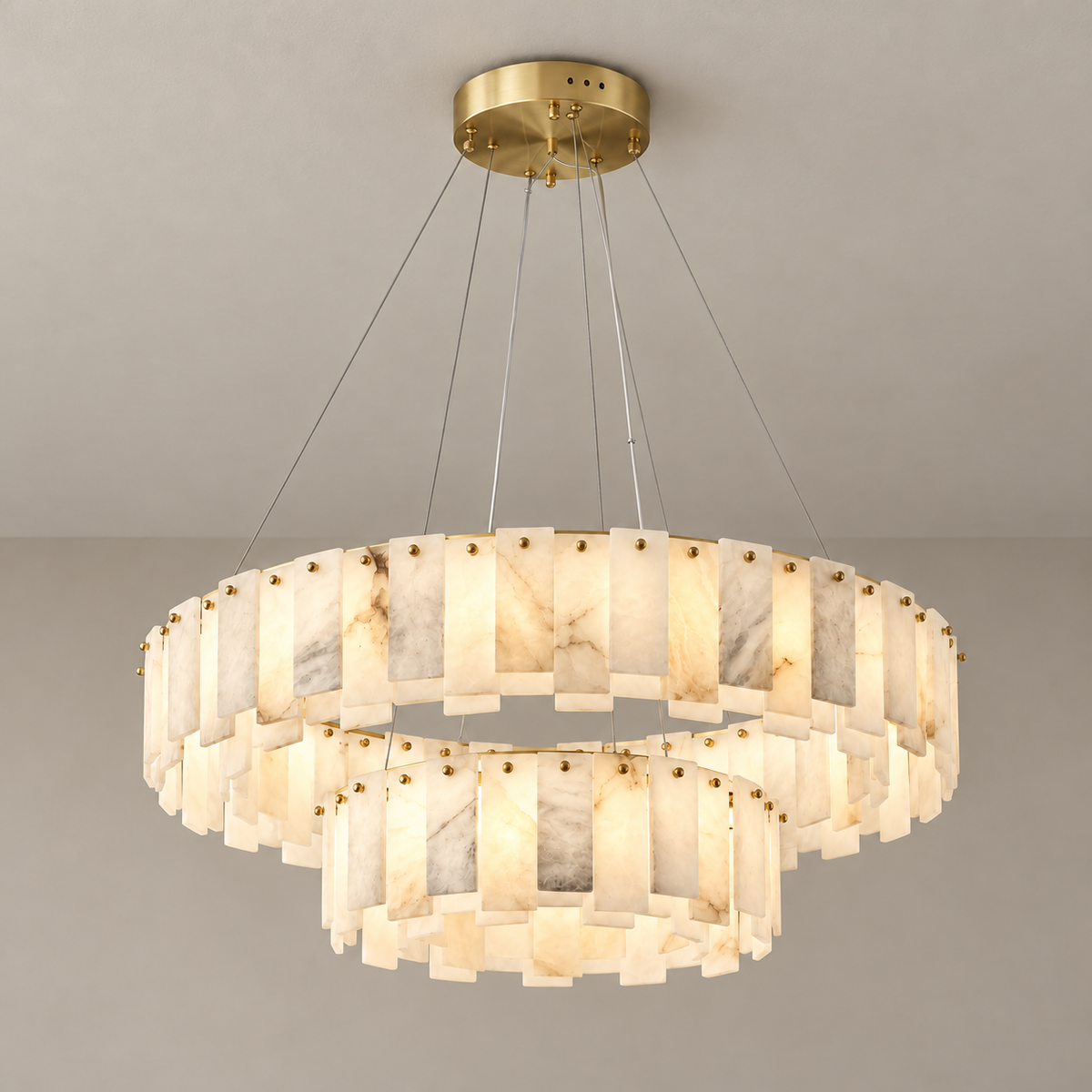 Double-ring alabaster chandelier illuminated, with natural mineral clouds visible through the stone.