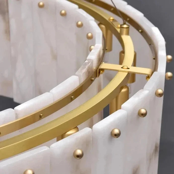 Back view of the double-ring chandelier’s brass support rail and alabaster panel edges.