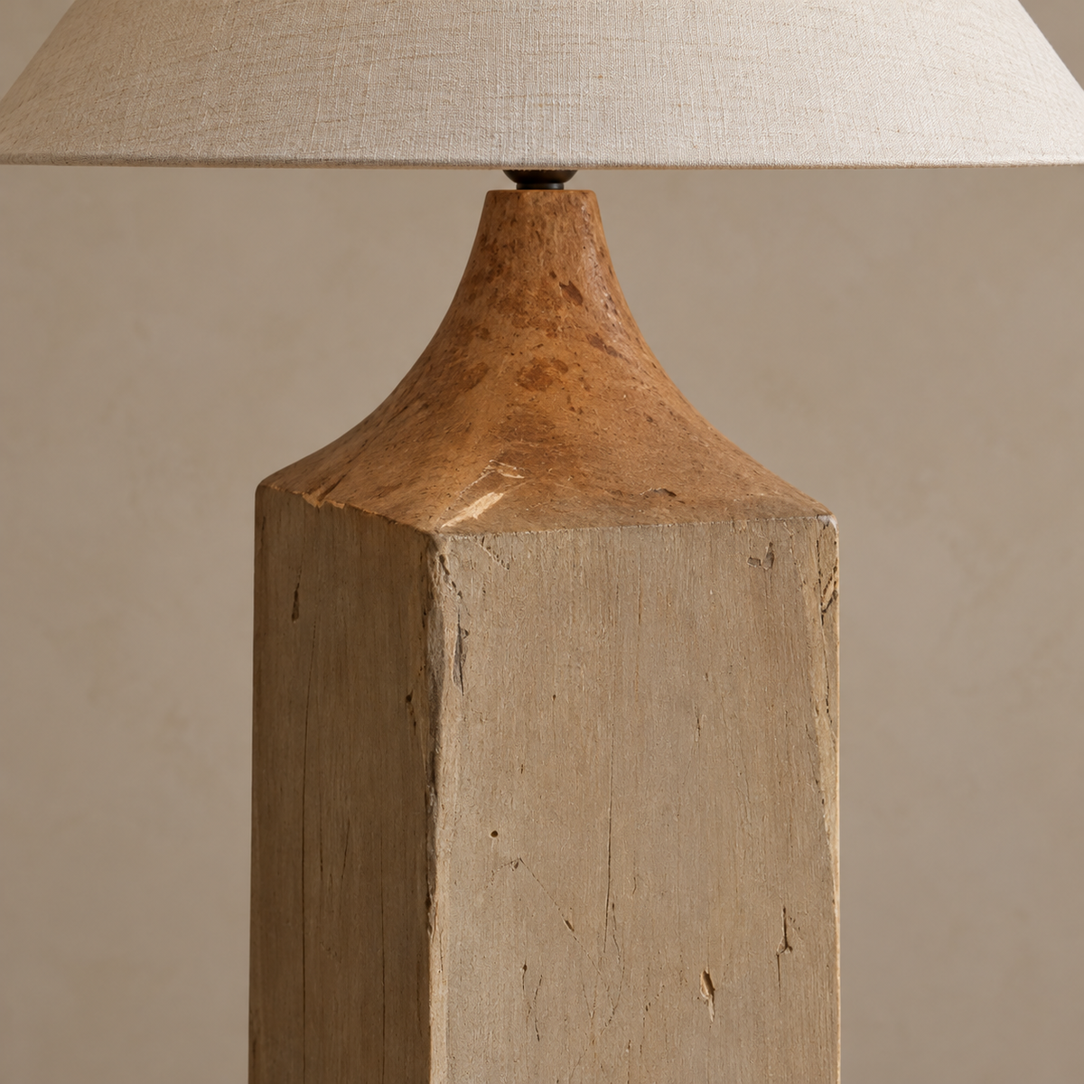 Close-up of Elkann’s curved wood shoulder, timber marks and linen shade edge