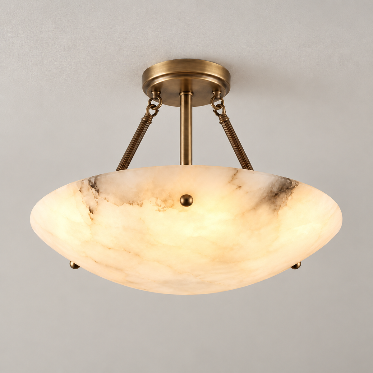 Flat Rose alabaster ceiling light illuminated, with its natural cloudy stone and veins visible.
