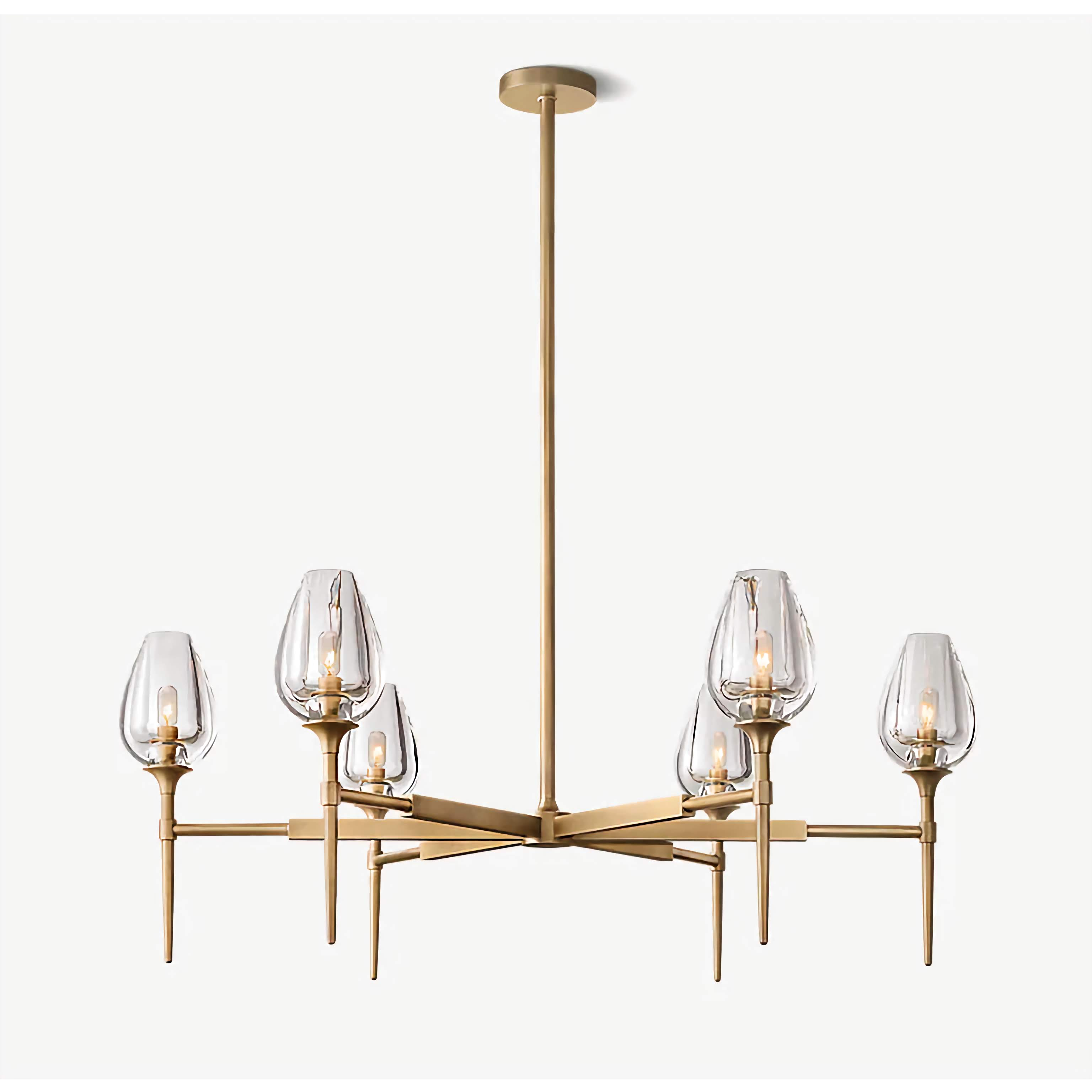 Smoked glass and brass candle chandelier over a dining table