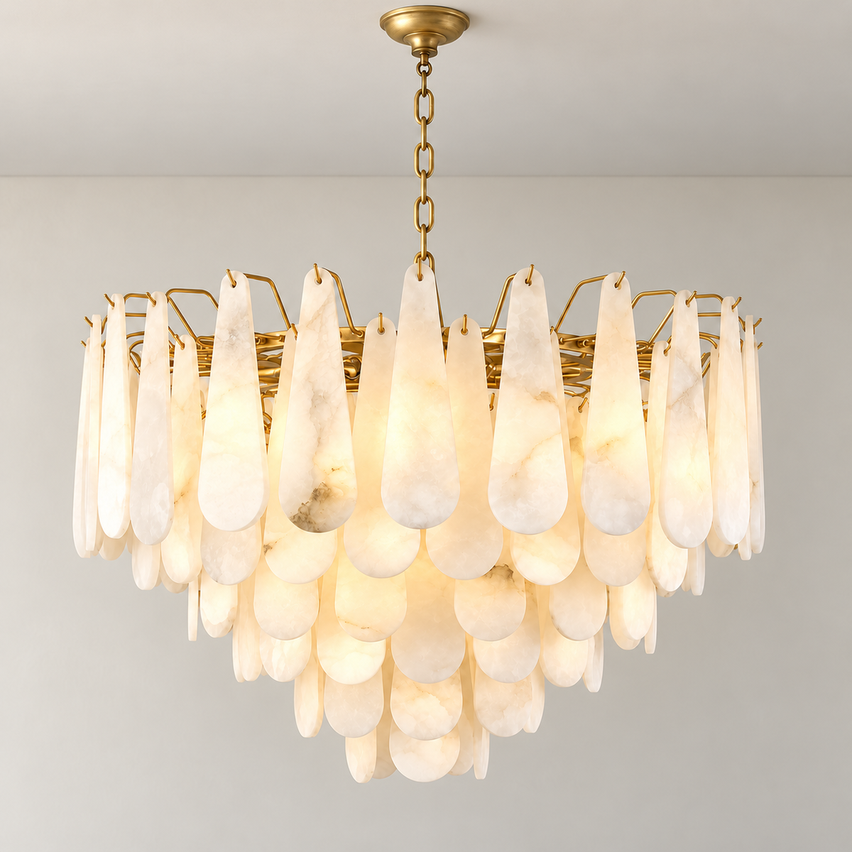 Goccia chandelier illuminated through softly clouded alabaster teardrops.