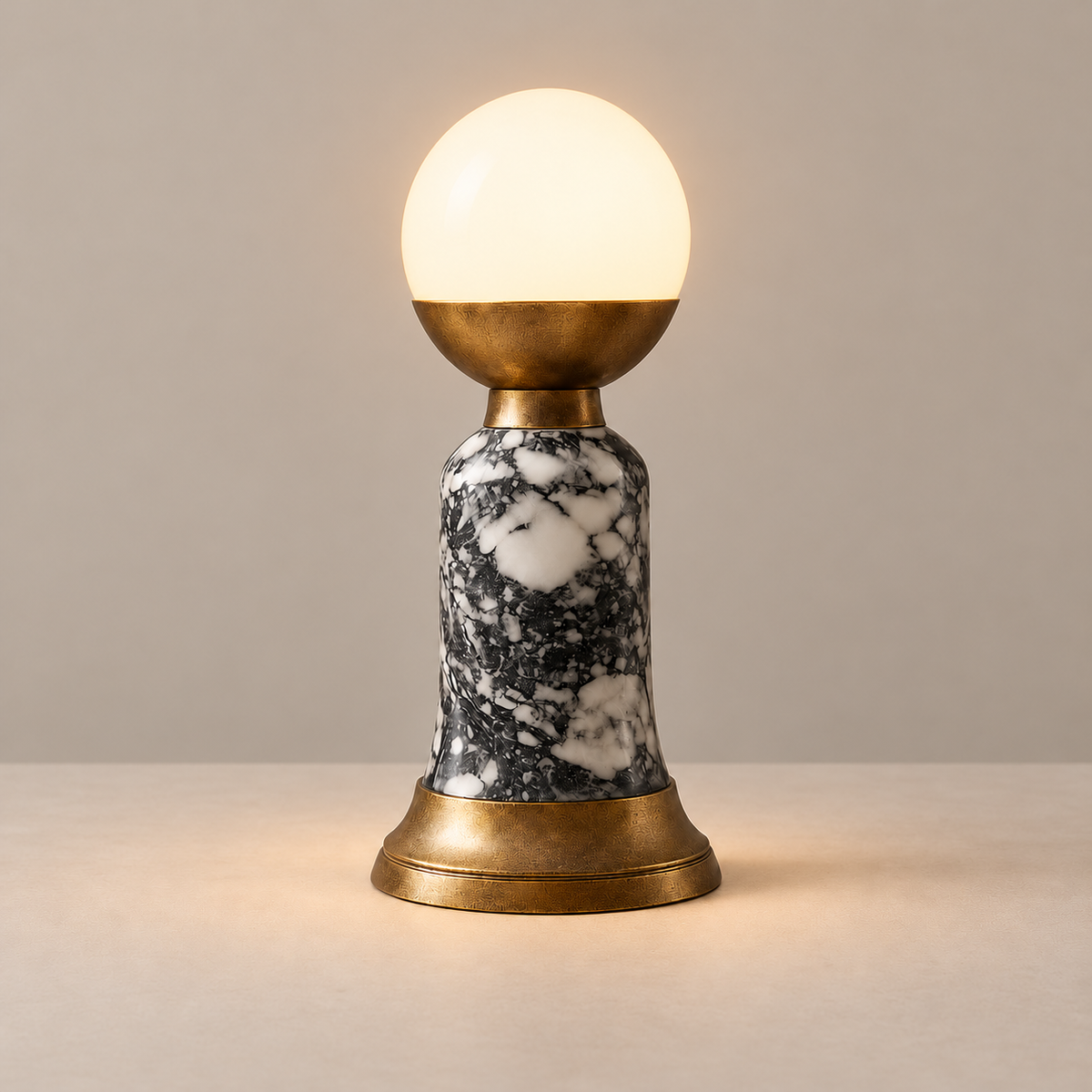 Grey Marble Table Lamp, illuminated, on a beige background.