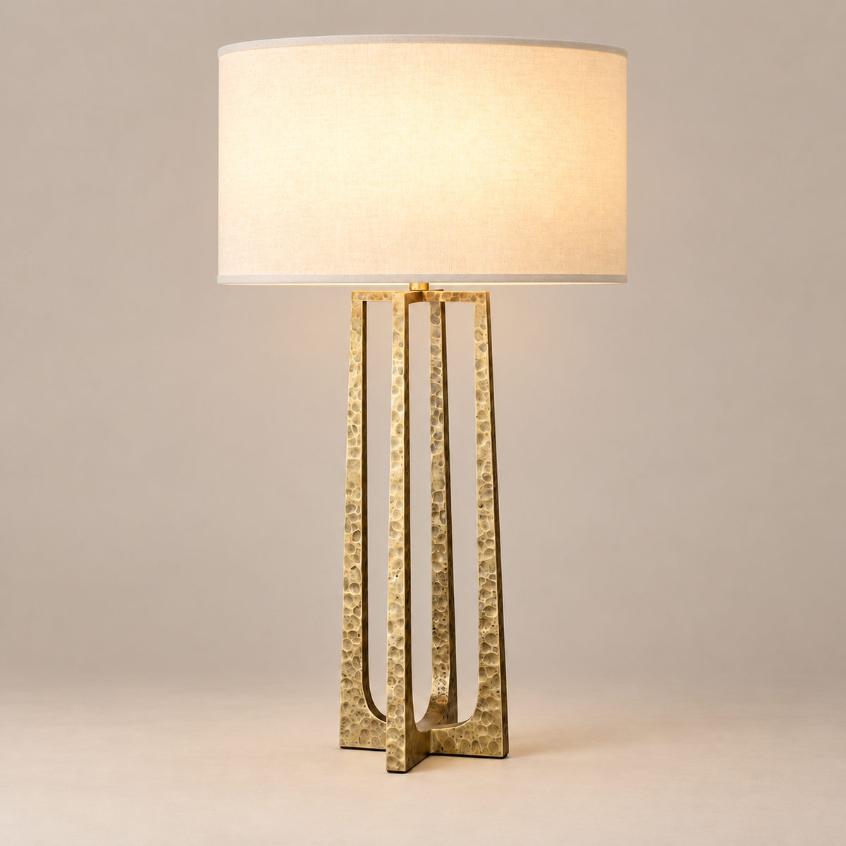 Hammered copper table lamp illuminated on a beige background