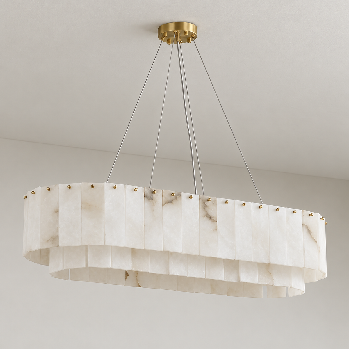 Joan oval alabaster chandelier, unlit, with natural cloudy stone panels and brass fittings.