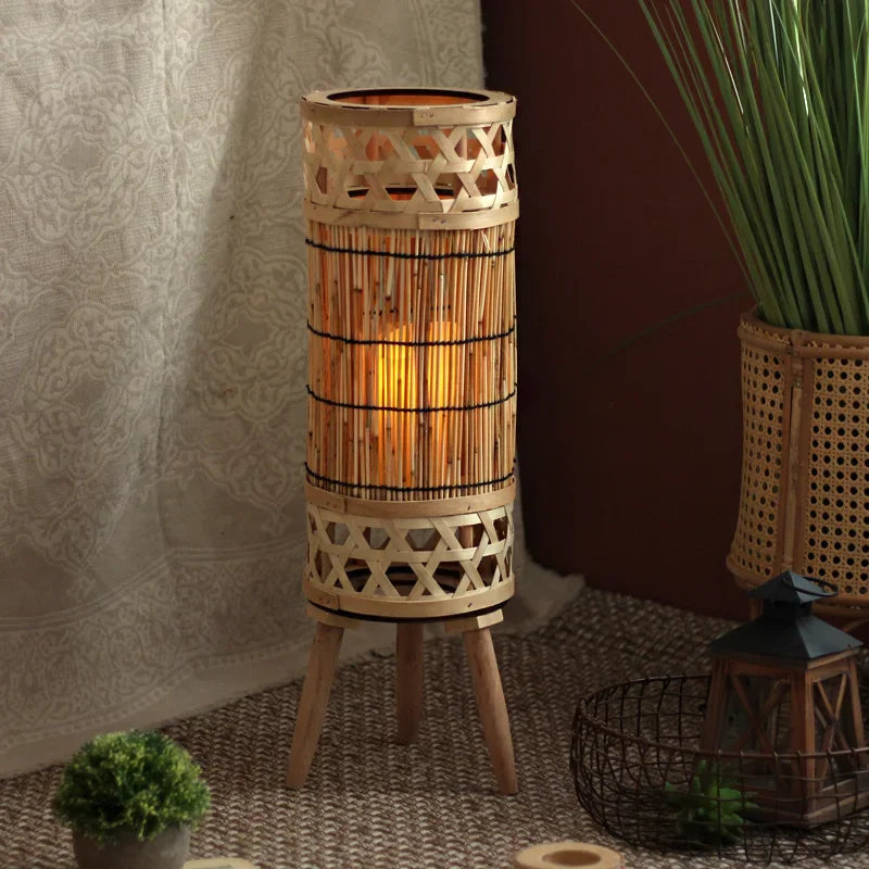 Trio of knitted bamboo tower lamps at varying heights