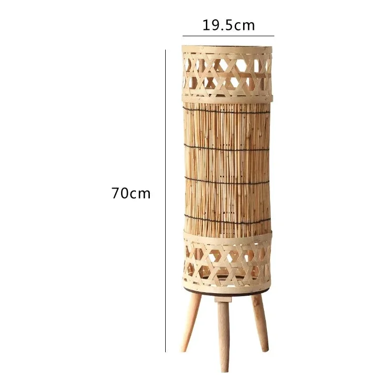 Handwoven bamboo tower lamp in a bedroom