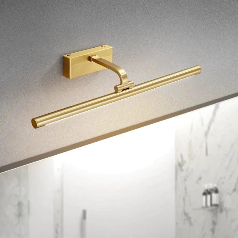 Brass LED picture light above a marble bathroom wall