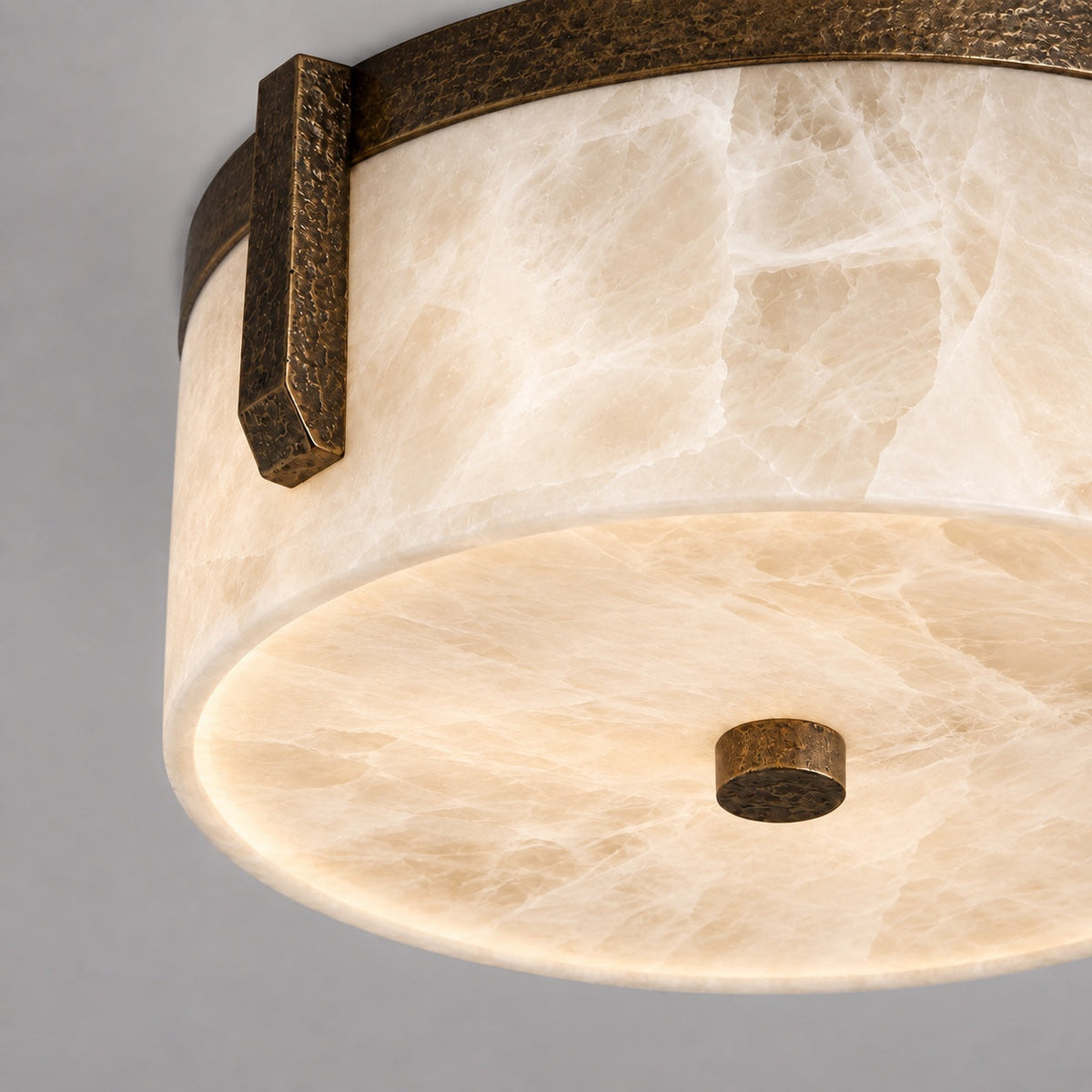 Linnea alabaster flush mount lit from below, showing the stone veining, CLND036-A