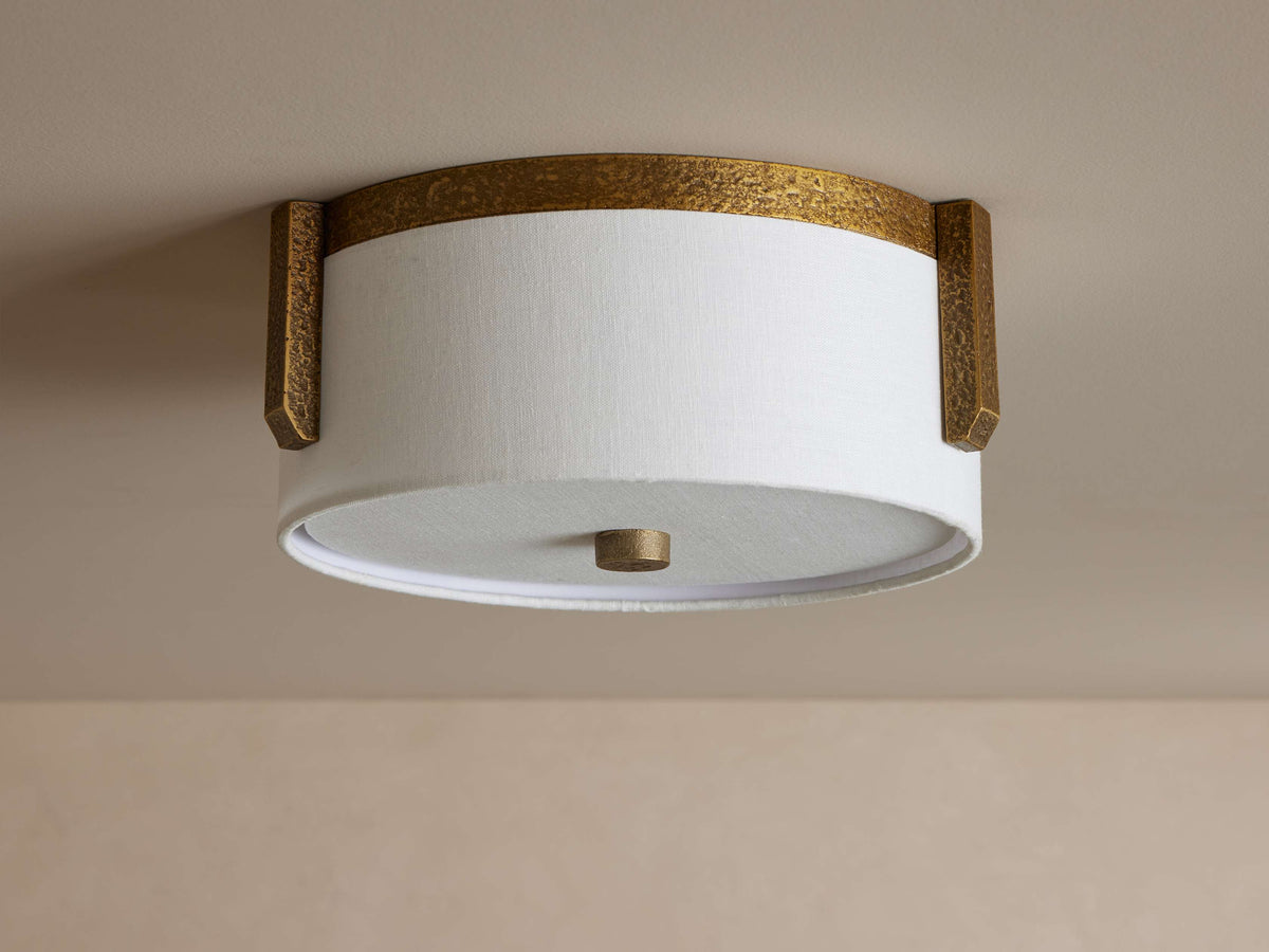 Linnea flush mount unlit, white linen drum in a hammered antique brass band with three brass brackets