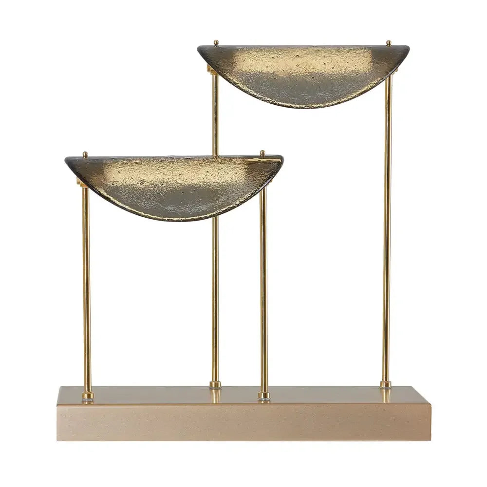Studio-shaped glass diffusers on a brushed brass spine glowing warm