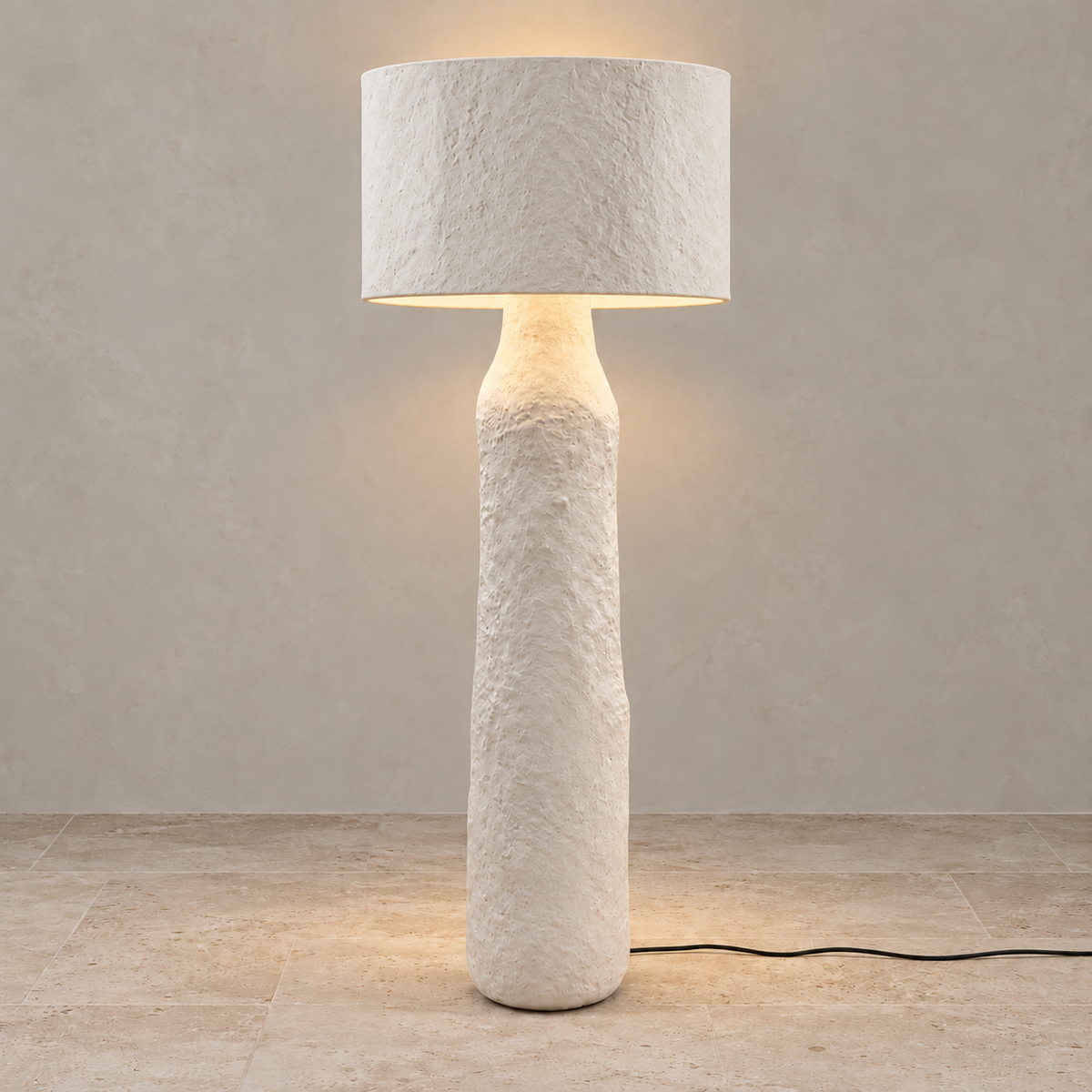 Mountain floor lamp lit beneath its opaque textured shade.