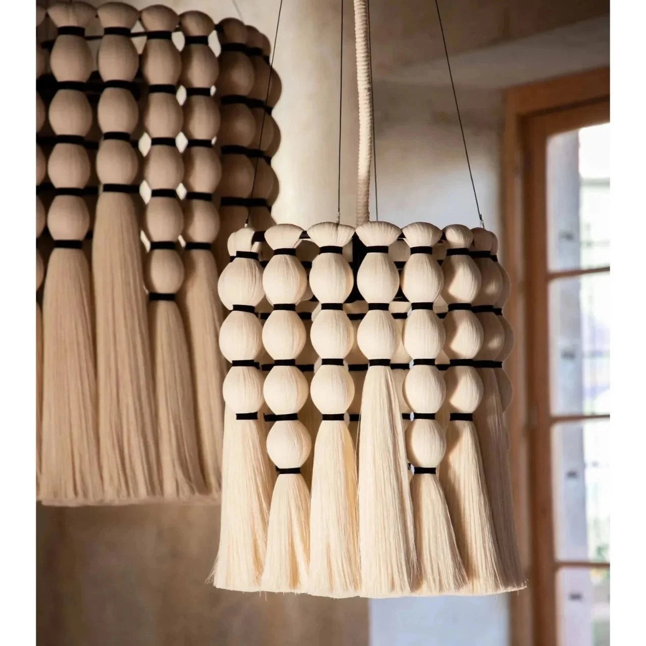Organic cotton fringe pendant handwoven with beads in a bedroom