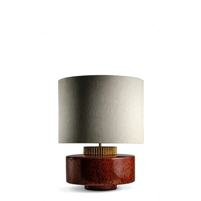 Red ceramic table lamp glowing warm