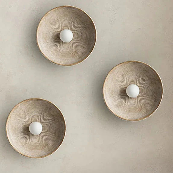 Circular iron sconce casting soft light