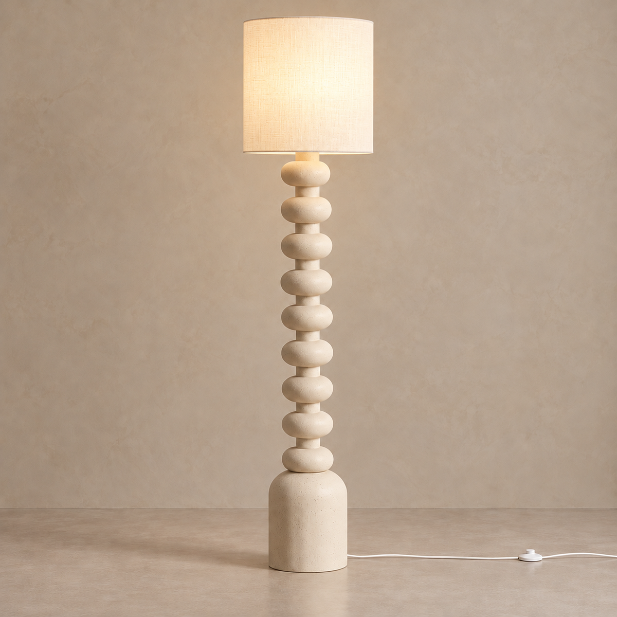 CL7774033 stacked resin floor lamp with its white fabric shade illuminated.