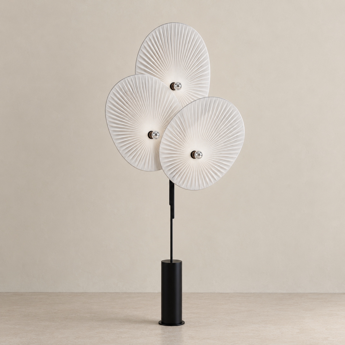 White Svelo floor lamp on a beige floor, showing its pleated shades and slender black stand.