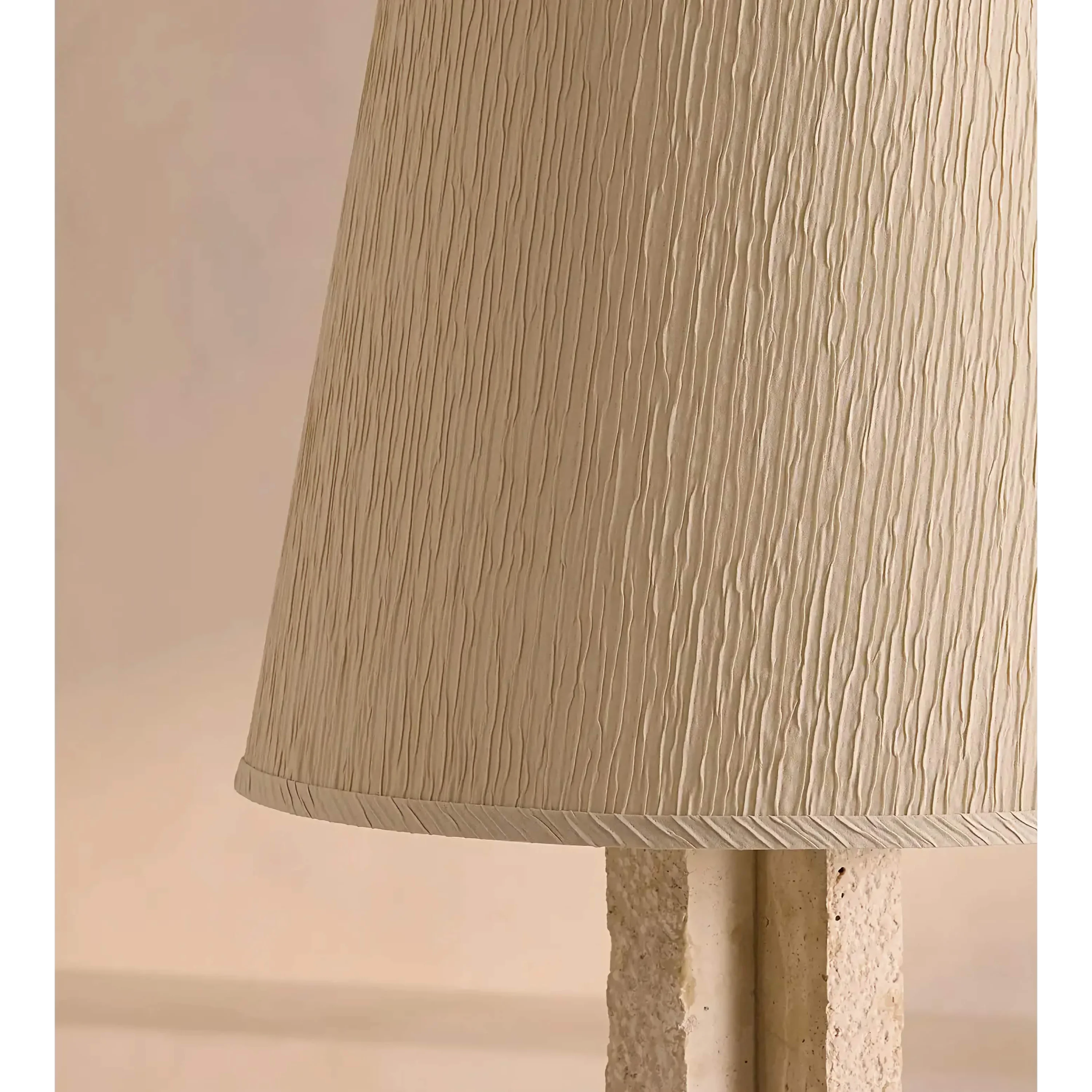 Travertine stone veining and cream pleated shade detail