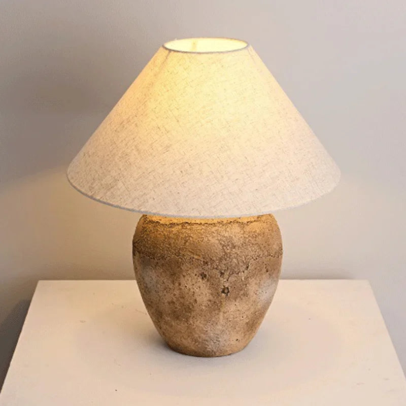 Wabi-sabi ceramic lamp glowing warm