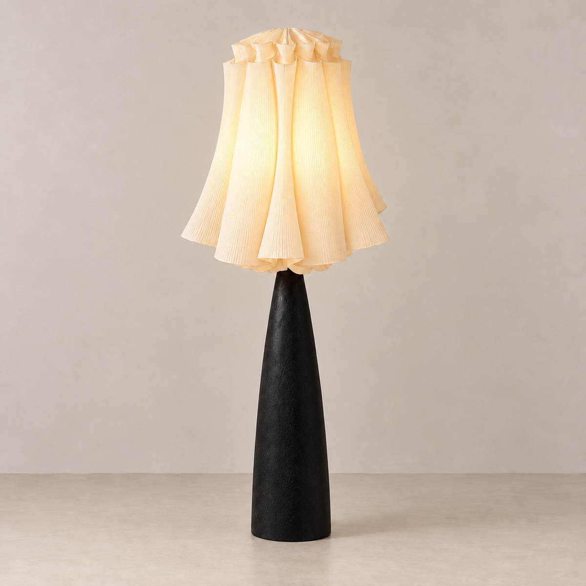 Viterbo floor lamp illuminated, with soft light passing through its pleated linen shade.
