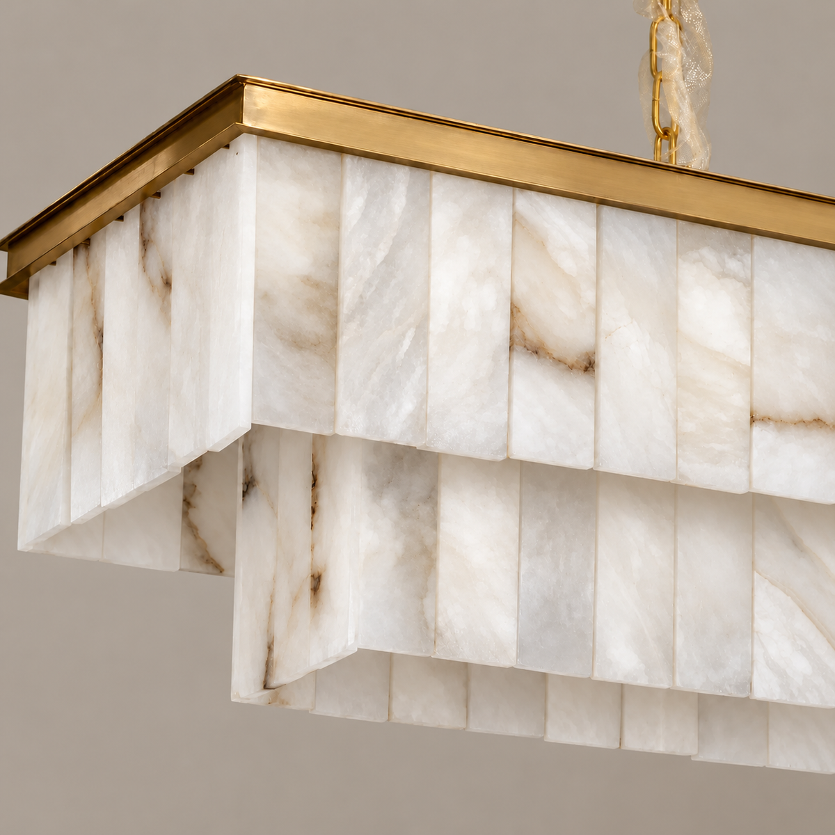Close-up of Volterra’s layered alabaster panels and brass frame
