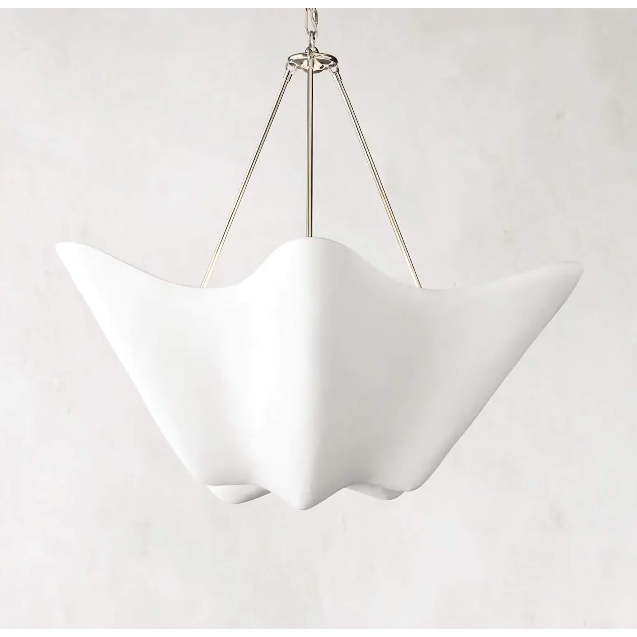 White plaster wave pendant over a dining table